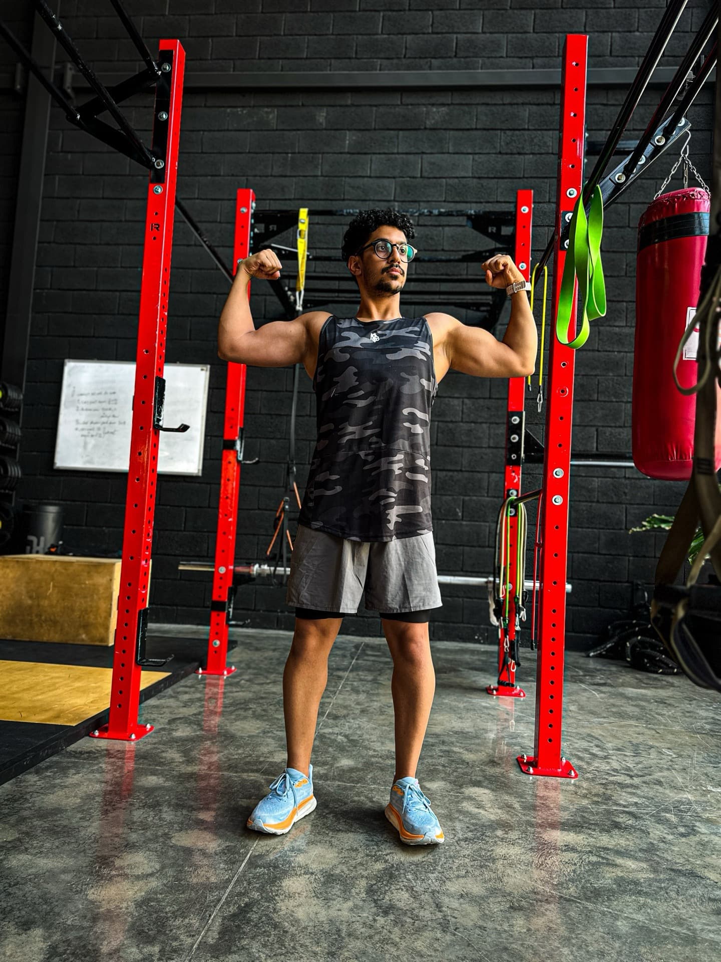 Kasra Madihi coaching a barbell lunge in the gym